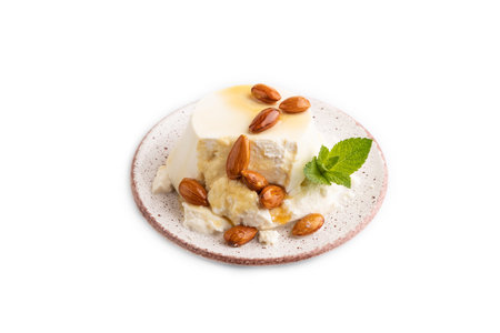 Ricotta cheese with honey and almonds isolated on white background. side view, close up.