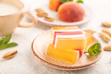 Almond milk and peach jelly on gray concrete background. side view, close up, selective focus.の写真素材