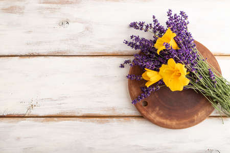 Beautiful day lily and lavender flowers on white wooden background, flat lay, top view, copy space.の写真素材