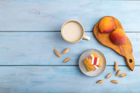 Almond milk and peach jelly on blue wooden background. top view, flat lay, copy space.の写真素材