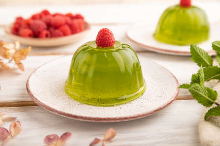 Mint and raspberry green jelly on white wooden background. side view, close up, selective focus.の写真素材