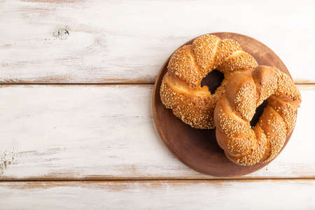 Homemade sweet bun on a white wooden background. top view, flat lay, copy space.の写真素材