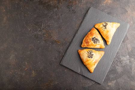 Homemade asian pastry samosa on black concrete background. top view, flat lay, copy space.の写真素材