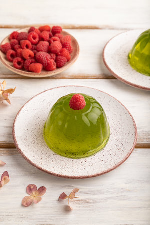 Mint and raspberry green jelly on white wooden background. side view, close up.の写真素材