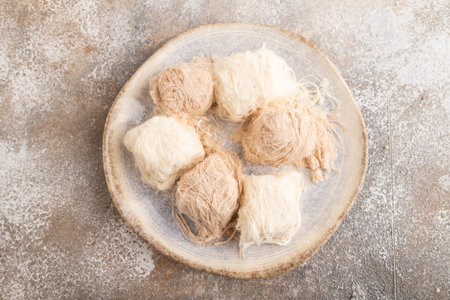 traditional arabic sweets pishmanie on brown concrete background. top view, flat lay, close up.