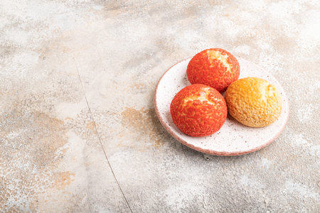 Traditional french custard dessert shu cake on brown concrete background. side view, copy space....