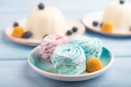 White milk jelly with marshmallow on blue wooden background. side view, close up, selective focus.の写真素材