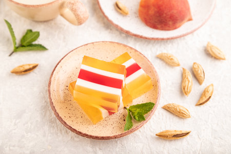 Almond milk and peach jelly on gray concrete background. side view, close up, selective focus.の写真素材