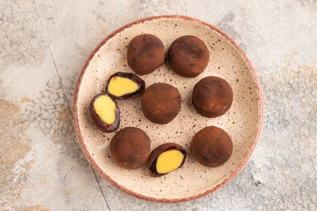 Japanese rice sweet buns chocolate mochi filled with cream on brown concrete background. top view,...