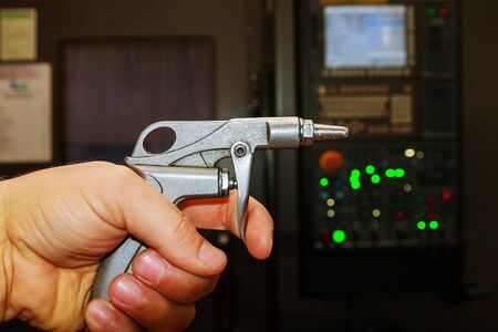 Blow Gun, Air compressor gun in hand at the factory.の写真素材