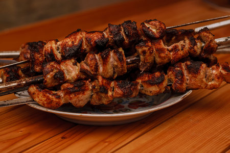Shish kebab on a plate on a wooden table. shashlik