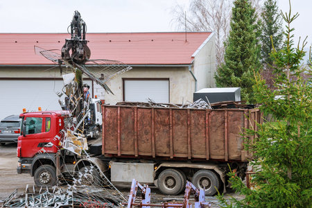 Skutec, Czech Republic, 21 November 2019: A grapple truck loads scrap industrial metal for recycling