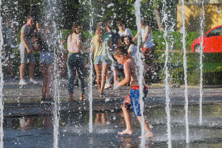 Uzhhorod, Ukraine, 30 June 2019: Children bathe in the fountain on a hot summer day.のeditorial素材