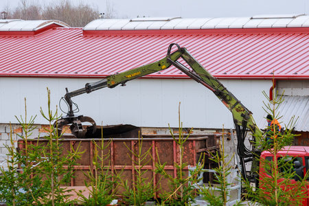 Skutec, Czech Republic, 21 November 2019: A grapple truck loads scrap industrial metal for recycling