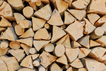 Stack of dry chopped wooden logs. natural wooden background with timber.