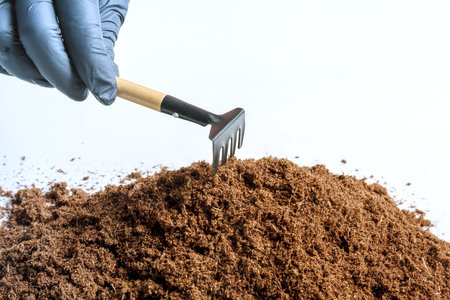 pile of fertile land on a white background. Garden tools.の写真素材