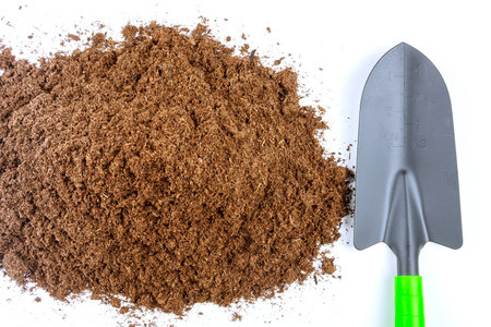 pile of fertile land on a white background. Garden tools.