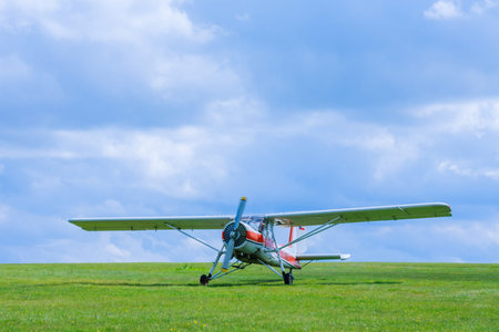 Small aircraft before takeoff on the field aginst blue sky