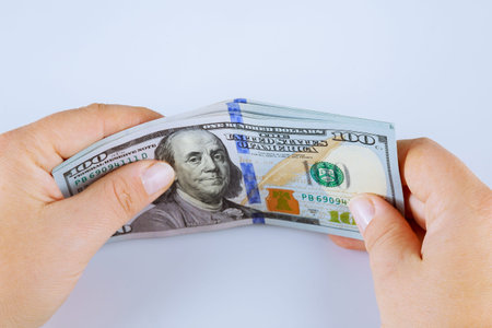 American dollars on a gray background. One hundred dollar bills.