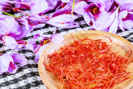 The process of separating the saffron strands from the rest of the flower. Preparing saffron threads for drying before using in cooking, cosmetology or medicine.の写真素材