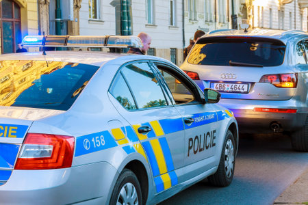 Prague, Czech Republic - October 4, 2020: A policeman in a police car with flashing red and blue lights stopped an SUV in Pragueのeditorial素材
