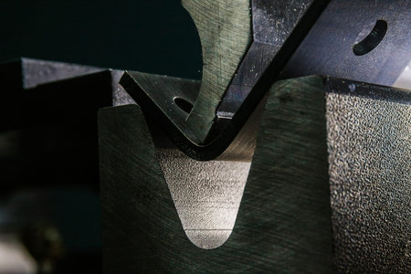 working with sheet metal on CNC hydraulic press brake. Bending sheet metal