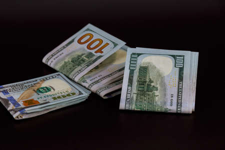 One hundred dollar bills on black backgroundの写真素材