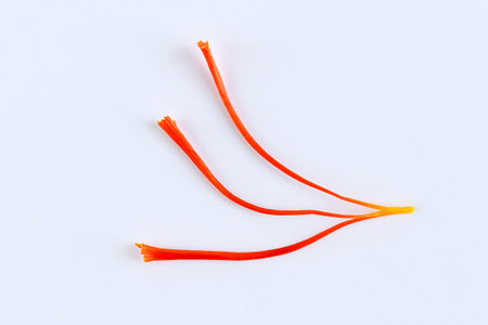 Single stamen of saffron close-up on a white background. Crocus. Spice.