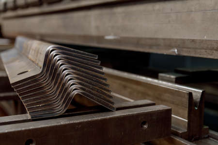 A stack of sheet metal products after processing on a bending machine.の写真素材