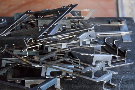 Products bent on a bending machine, close-up. Factory made metal parts.