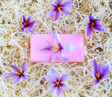 Saffron flower lies on saffron soap, saffron flowers around soap.の写真素材