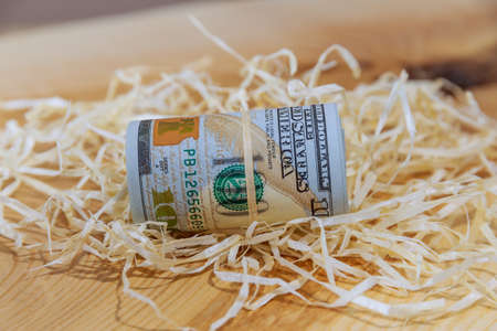 Close-up of rolled up American dollars banknotes. One hundred dollar bills. View from above.の写真素材