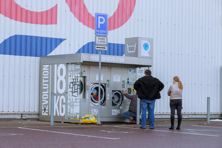 20 January 2021 Pardubice, Czech Republic: People stand in line near the washing machines that are...