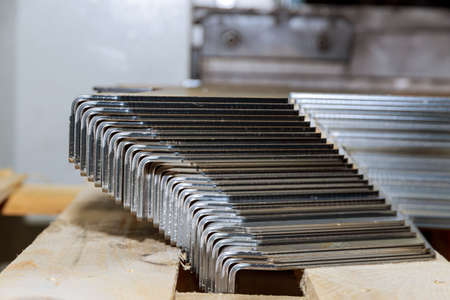 A stack of sheet metal products after processing on a bending machine.の写真素材