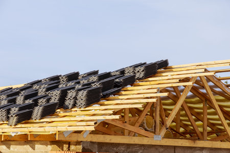 Top view, wooden roof structure from frame beams of a farm house, metal tiles. building a house.