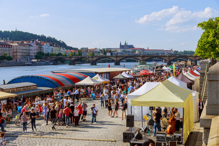 22 May 2022 Prague, Czech Republic. The embankment near the river is full of passing tourists.のeditorial素材