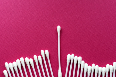 line of ear sticks on pink backgroundの写真素材
