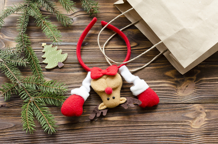 toy deer in kraft paper bag, gift box, fir on wooden tableの写真素材