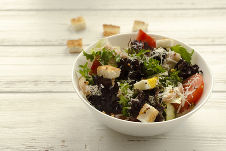 Salad, caesar  on white wooden background and copy spaceの写真素材