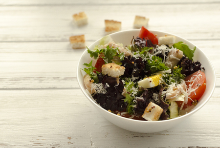 Salad, caesar  on white wooden background and copy spaceの写真素材