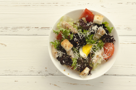 Salad, caesar  on white wooden background and copy spaceの写真素材
