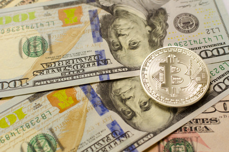 Silver bitcoin on dollar backgroundの写真素材