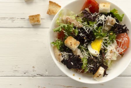 Salad, caesar  on white wooden background and copy spaceの写真素材