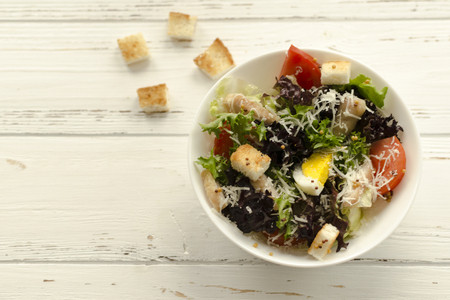 Salad, caesar  on white wooden background and copy spaceの写真素材