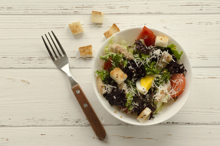 Salad, caesar  on white wooden background and copy spaceの写真素材
