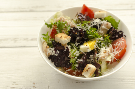 Salad, caesar  on white wooden background and copy spaceの写真素材
