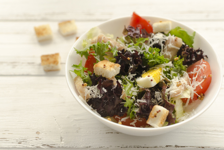 Salad, caesar  on white wooden background and copy spaceの写真素材