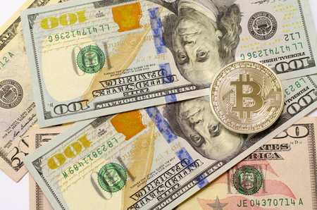 Silver bitcoin on dollar background の写真素材