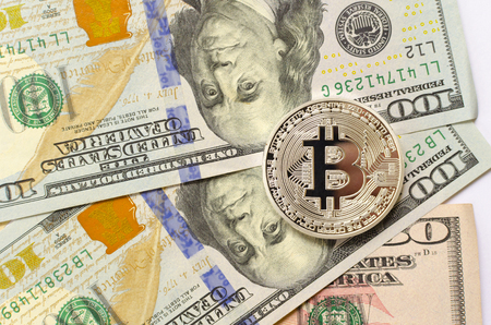 Silver bitcoin on dollar backgroundの写真素材