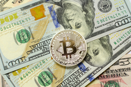 Silver bitcoin on dollar backgroundの写真素材